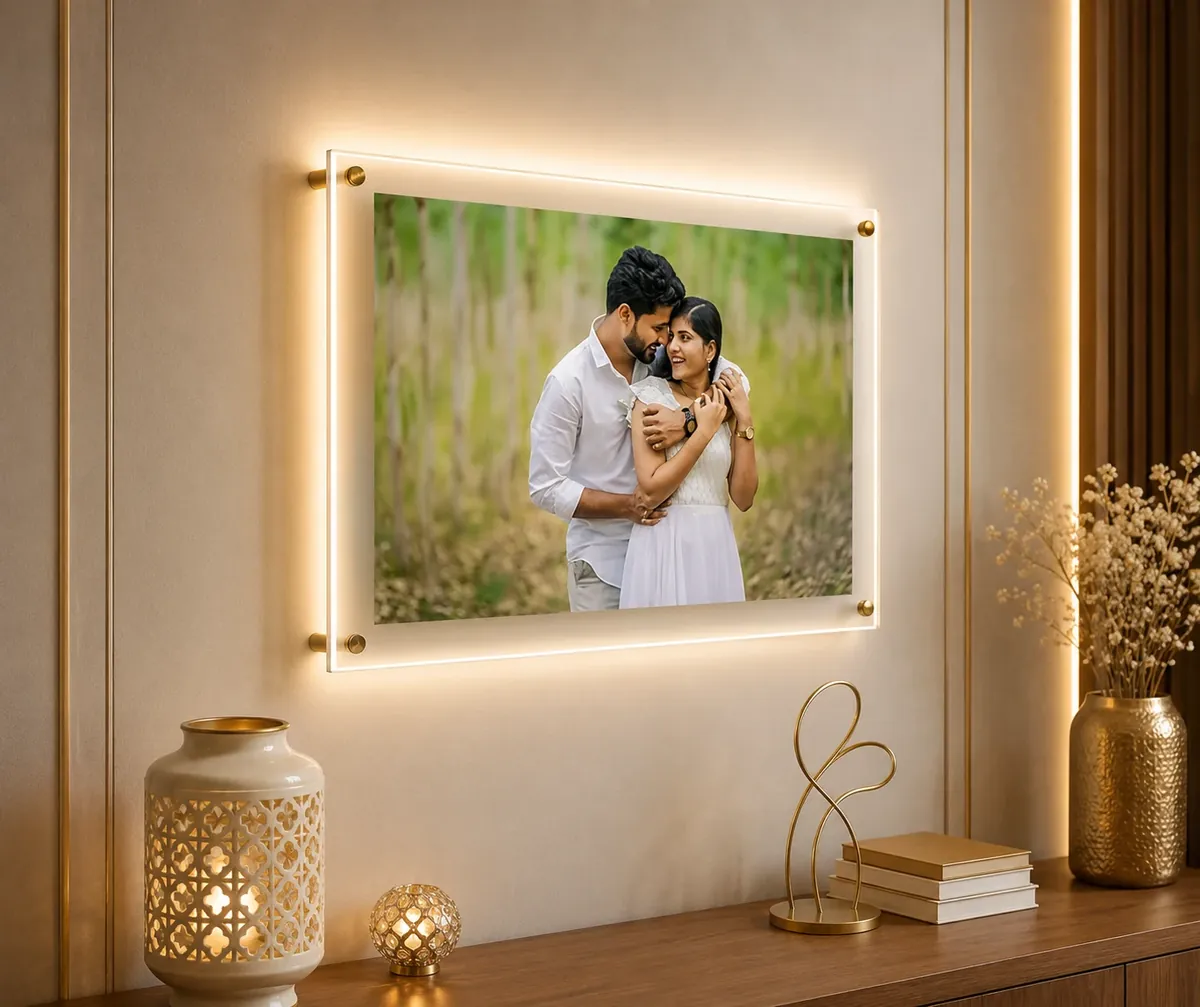 Floating acrylic photo frame lit from behind, a couple’s portrait held off the wall on brass standoffs — Siri Print World, Palakollu