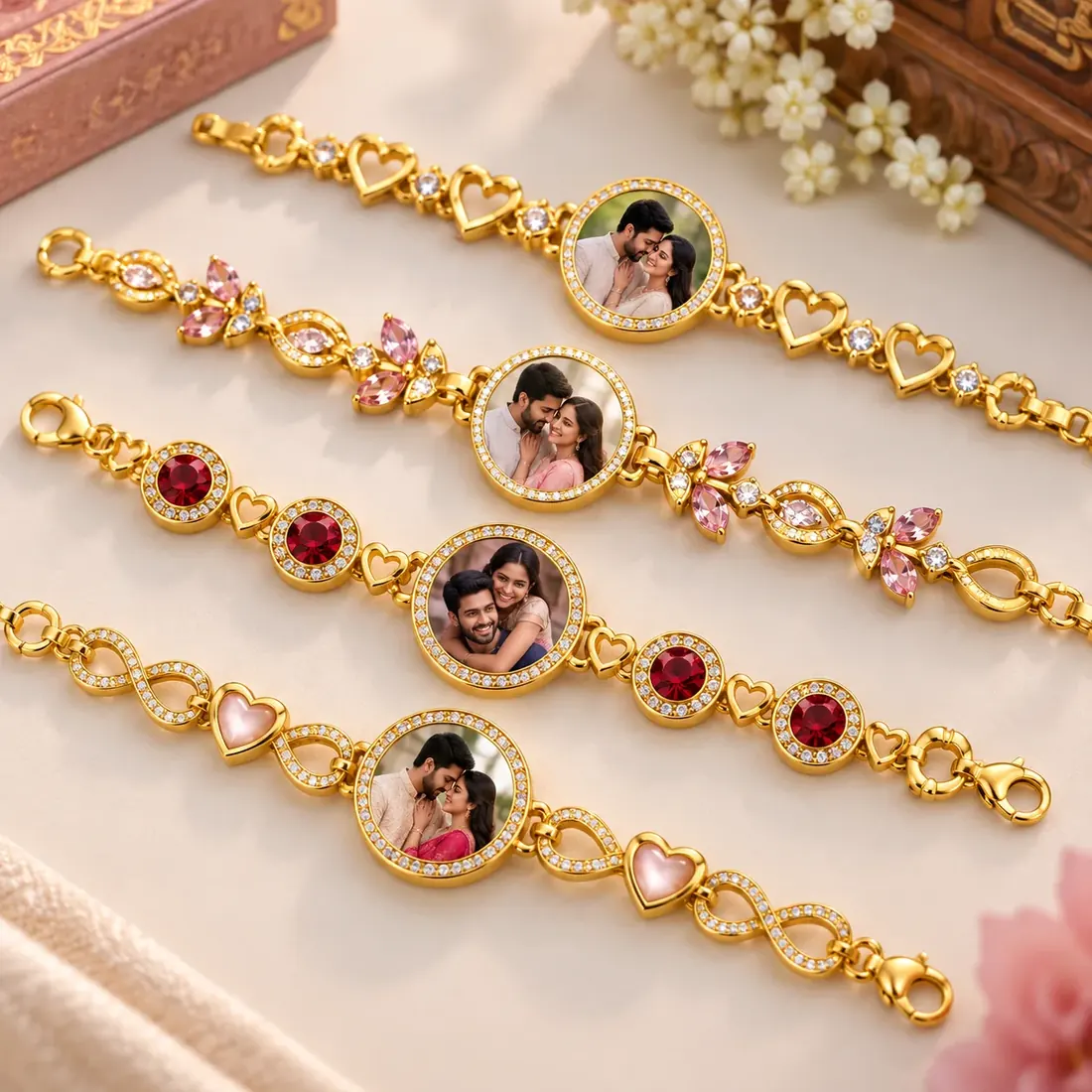 Four gold photo bracelets with a couple’s portrait set in a crystal-edged round charm, in heart, floral, ruby and infinity link styles — Siri Print World, Palakollu