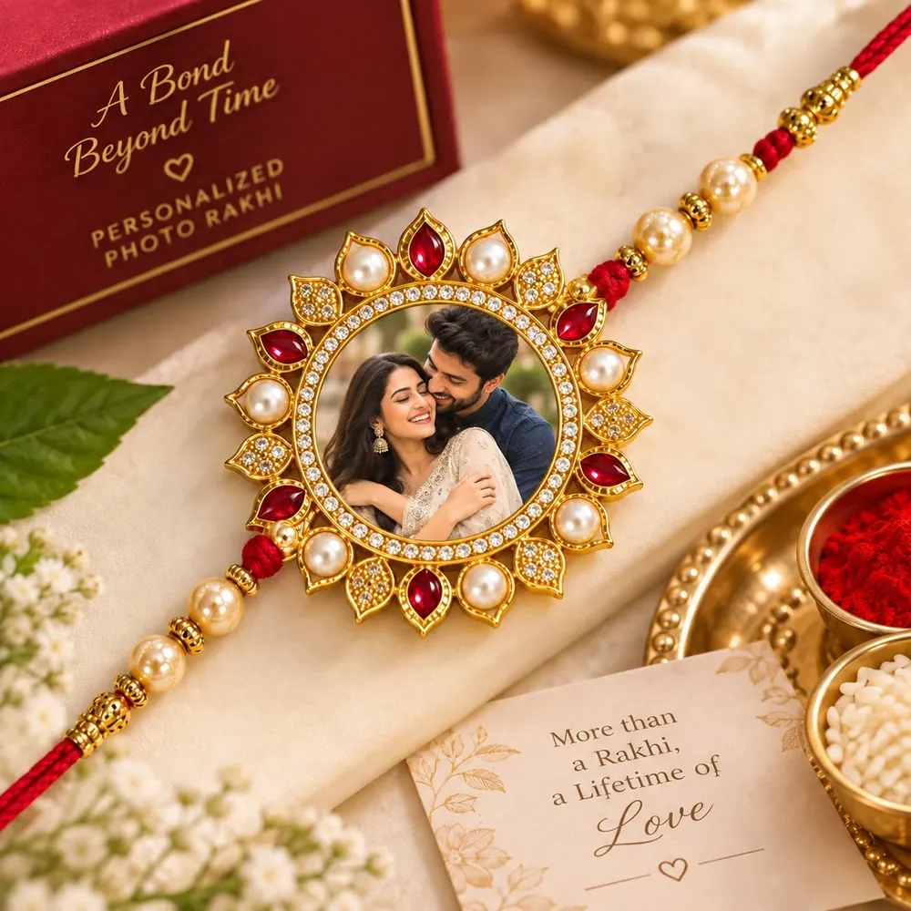 Personalised photo rakhi from Siri Print World, Palakollu — gold, pearl and ruby-stone rakhi with a printed photo centre, gift box and pooja thali
